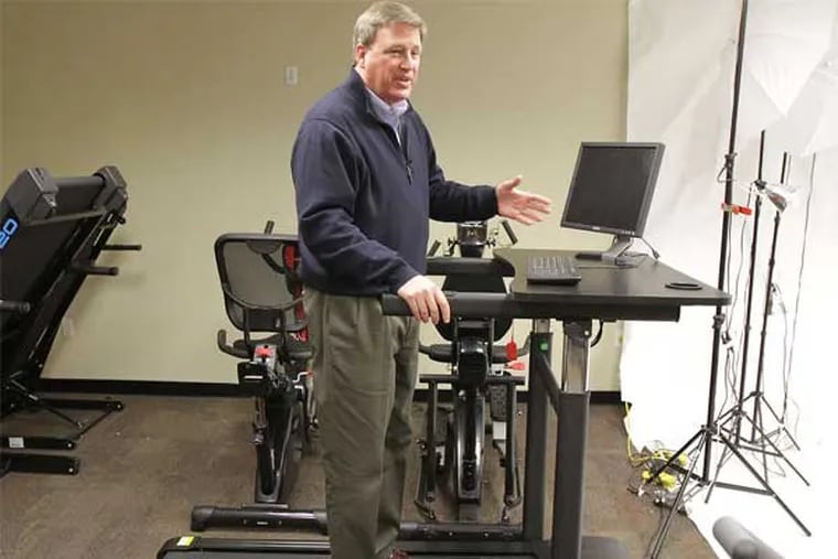 Smooth Fitness CEO Rich Hebert explains the low-speed treadmill desk, designed for all the boomers expected to be working for years to come. (David Swanson / Staff Photographer)