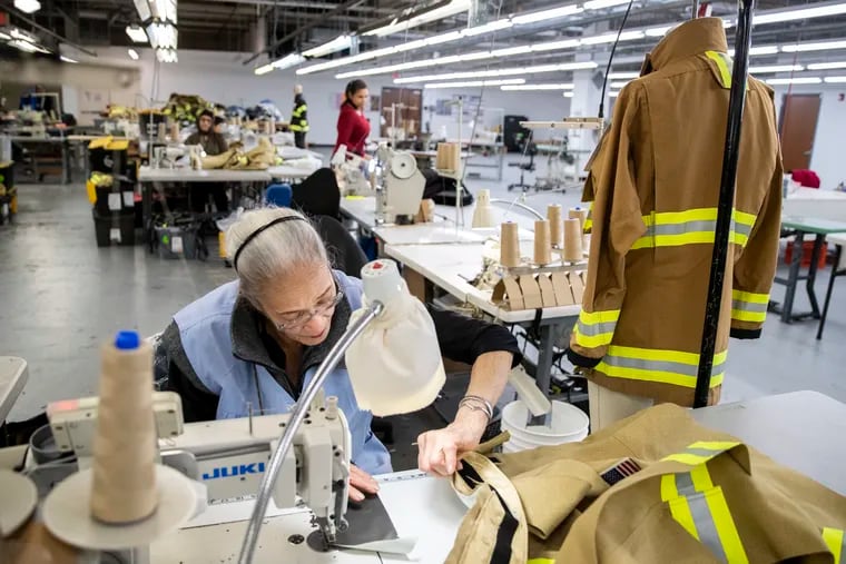 Argentina Feliciano works on firefighting apparel at the Ricochet manufacturing facility in Philadelphia, Pa. on Monday, April 10, 2023. Ricochet produces protective clothing for the military, industrial chemical workers and first responders.
