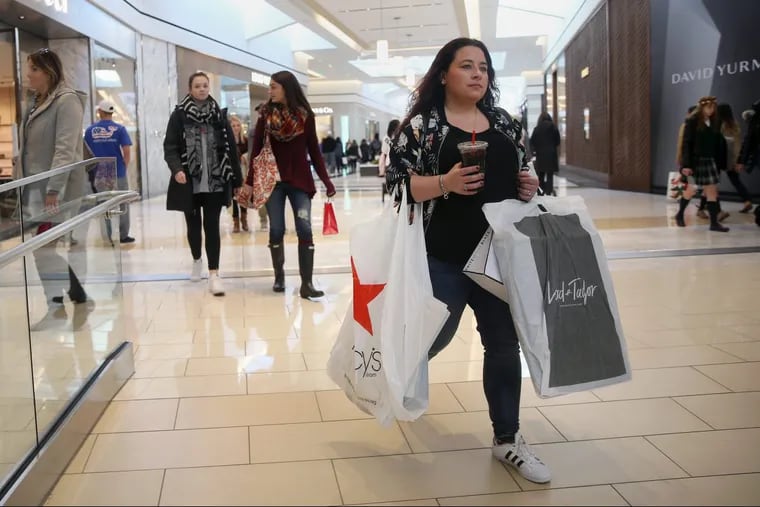 Crunchtime: Amanda Perwien of Broomall juggles bags and her beverage as she goes Christmas shopping at King of Prussia Mall on Thursday, The region’s malls are ready for the expected swarm of last minute shoppers in the final leg of the holiday shopping season this weekend.