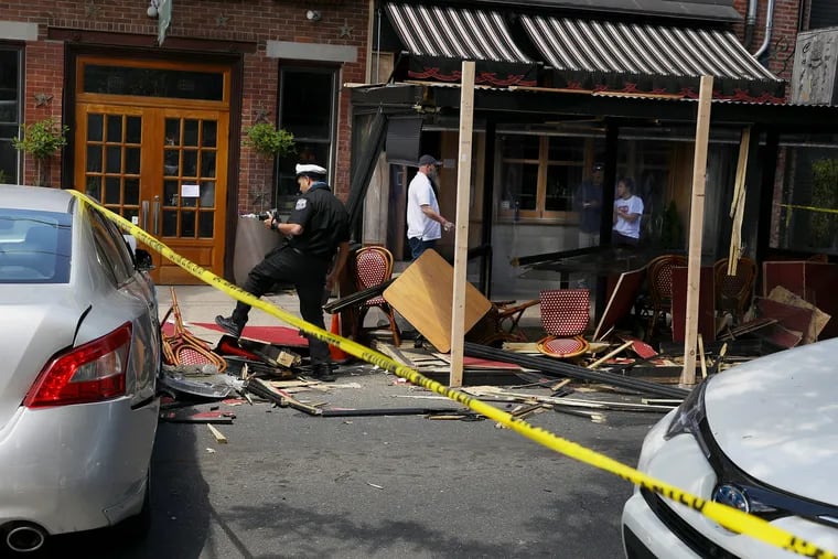 Philadelphia Police investigate the scene after a vehicle crashed into the outdoor dining structure at Café La Maude.