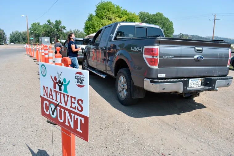 Vehicles stopped at a drive-thru U.S. Census participation campaign organized by Montana Native Vote on the Crow Indian Reservation in Lodge Grass, Mont. on Aug. 26.
