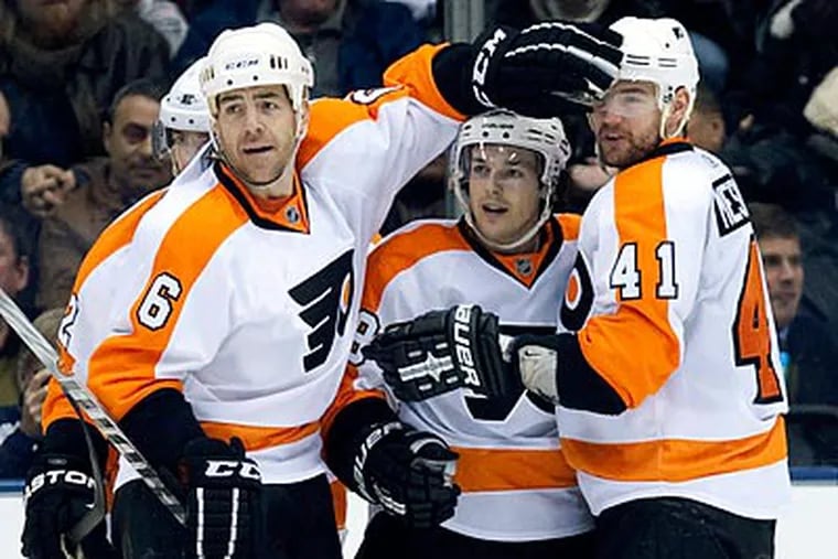 Danny Briere is congratulated by Sean O'Donnell and Andrej Meszaros after scoring. (Frank Gunn/AP Photo, The Canadian Press)