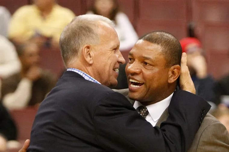 Sixers head coach Doug Collins who was drafted ahead of Doc Rivers' uncle in 1973, share a moment prior to a game at the Wells Fargo Center in 2018.
