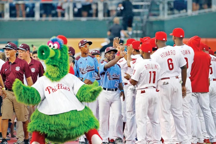 The Taney Little League World Series team meet members of the Phillies during a pre-game ceremony at Citizens Bank Park on Wednesday, August 27, 2014.