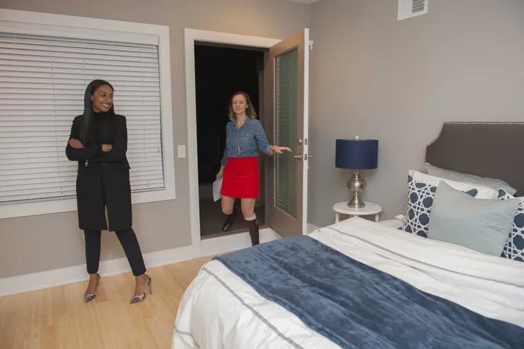 First time home buyer Jennifer Burks, left, views the master bedroom in a townhouse at 919 North 5th Street in Northern Liberties. She is assisted by realtor Meg Civera.