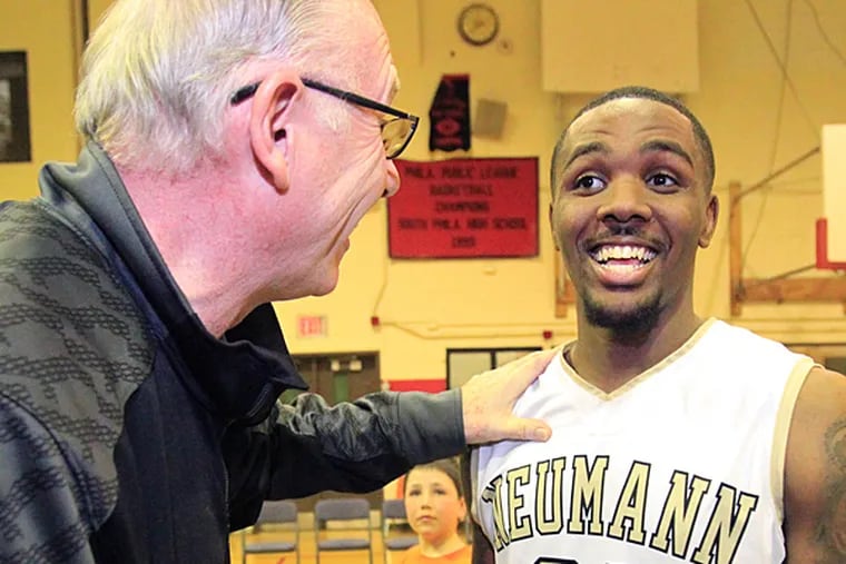 Ja'Quan Newton, right, of Neumann-Goretti  is congratulated by
University of Miami Coach Jim larranaga, left, after Newton broke the
all-time Catholic League scoring record on March 18, 2014.  (Charles Fox/Staff Photographer)