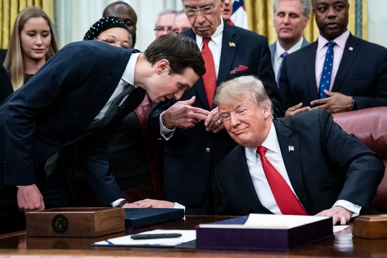 Jared Kushner, left, and President Donald Trump confer during a signing ceremony at the White House in December 2018. Trump's son-in-law pressured the president to grant him a long-delayed security clearance, and Trump instructed then-Chief of Staff John Kelly to fix the problem. Kelly told colleagues the move was not supported by intelligence officials. MUST CREDIT: Washington Post photo by Jabin Botsford