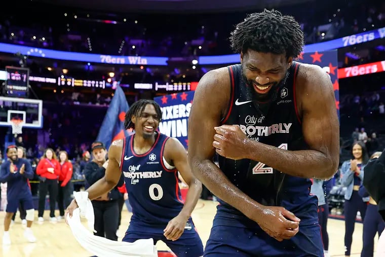 Sixers center Joel Embiid celebrates with teammate guard Tyrese Maxey after scoring 70 points against the San Antonio Spurs on Monday. Embiid owns the team record for points in a game, breaking Wilt Chamberlain's record of 68.