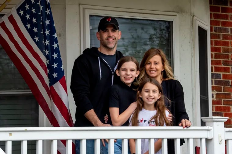 Jason and Corrin DeMent and their daughters Natalee (left), 12, and Adilynn (right), 10,  pose for a photo on the porch of their Haddon Township home March 25, 2020. They fear losing everything after the governor ordered the closure of their South Jersey fitness center as part of the coronavirus stay-at-home edict in New Jersey.