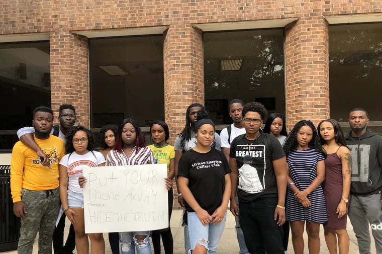Giavanna Roberson (in front, right of the student holding the sign) and Altaif Hassan (right of Roberson) were the students in the car stopped by police at Rowan University. Other students offer support and are upset at the police action.