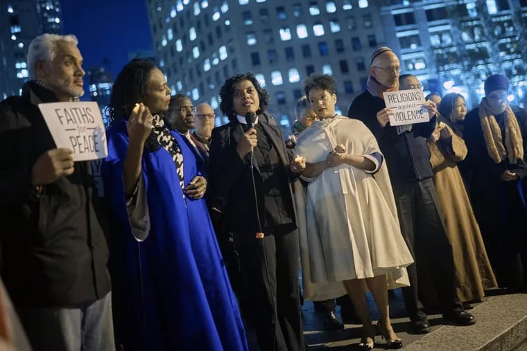 Community leaders speak at an interfaith vigil for peace in response to Tuesday’s terror attack in New York.