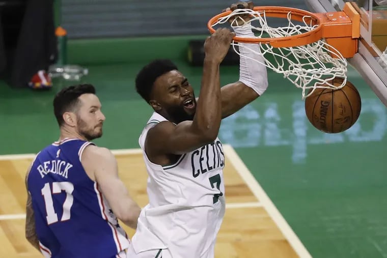 Celtics guard Jaylen Brown dunks the basketball past Sixers guard JJ Redick during the third-quarter in game two of the Eastern Conference semifinals on Thursday.