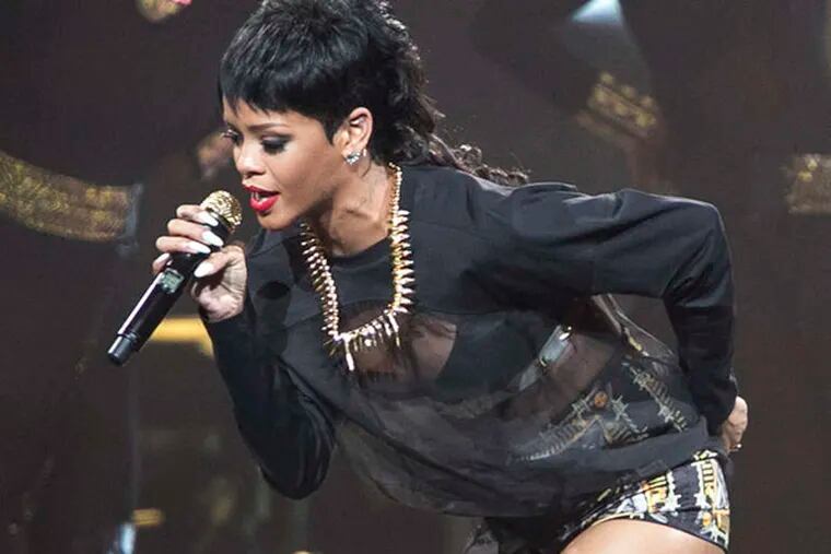 In this Sept. 24, 2013 file photo, Rihanna performs in Perth, Australia during the first concert of the Australian leg of her Diamonds World Tour. Thai authorities arrested a bar owner in connection with a lewd sex show mentioned in racy tweets by pop star Rihanna during her recent trip to Thailand, officials said Monday, Oct. 14, 2013, two weeks after an Instagram photo of her with a protected primate led to the arrest of other two men. (AP Photo/Lee Griffith, File)