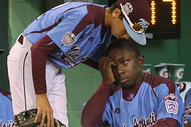 Taney's Jared Sprague-Lott, left, tries to console his teammate Zion Spearman, (Michael Bryant/Staff Photographer)