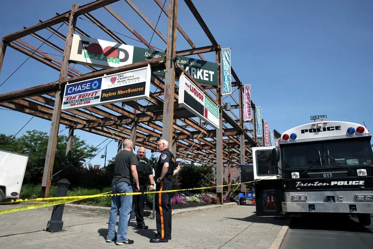 Police stand near an industrial area outside the warehouse building where the Art All Night Trenton 2018 festival was the scene of a shooting that resulted in numerous injuries and at least one death Sunday, June 17, 2018, in Trenton, N.J. (AP Photo/Mel Evans)