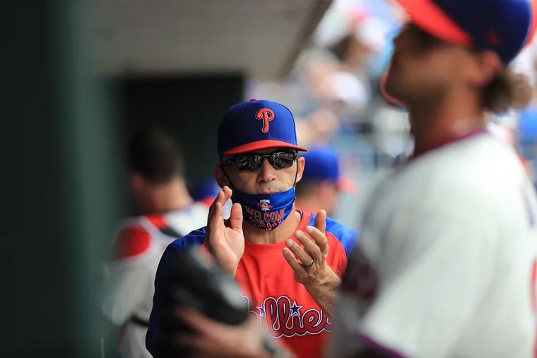 Philadelphia Phillies manager Joe Girardi applauds as Philadelphia Phillies starting pitcher Aaron Nola returns to the dugout in the fifth inning as the Phillies play the New York Yankees at Citizens Bank Park in Philadelphia, Pa. on June 13, 2021.