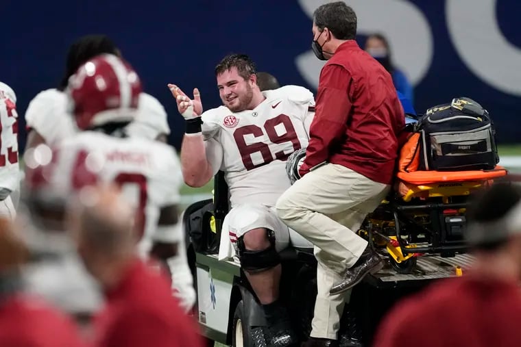 Alabama offensive lineman Landon Dickerson (69) is taken off the field after injury against Florida during the second half of the Southeastern Conference championship NCAA college football game, Saturday, Dec. 19, 2020, in Atlanta.