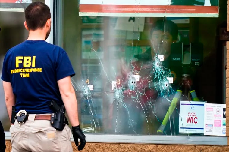 Investigators work the scene of a shooting at a supermarket in Buffalo, N.Y.
