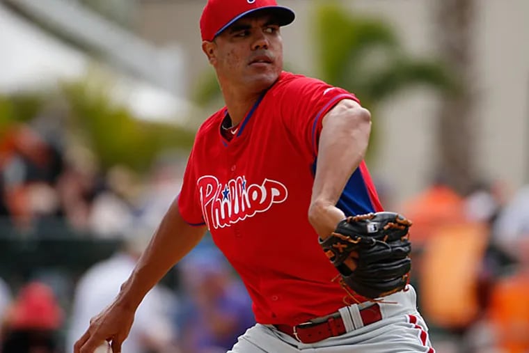 Phillies starting pitcher Miguel Alfredo Gonzalez throws in the fourth inning of an exhibition spring training baseball game against the Baltimore Orioles in Sarasota, Fla., Friday, March 7, 2014. (Gene J. Puskar/AP)