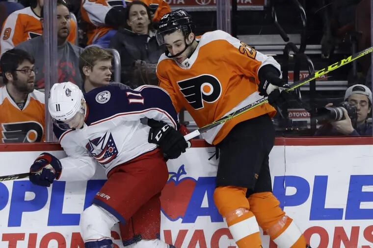 Columbus’ Matt Calvert, left, and the Flyers’ Brandon Manning collide during the third period of a recent game. Manning will return to the lineup Thursday after a two-game benching.