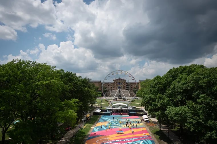 The Oval XP is home to a 33,000-square-foot ground mural called Common Ground, created by Philadelphia-based muralist and artist Carlos “CALO” Rosa. This view was photographed after a news conference Monday to announce the launch of the Oval XP, a summer-long experience that welcomes Philadelphians back to the Benjamin Franklin Parkway while uplifting and investing in the city’s creative economy.