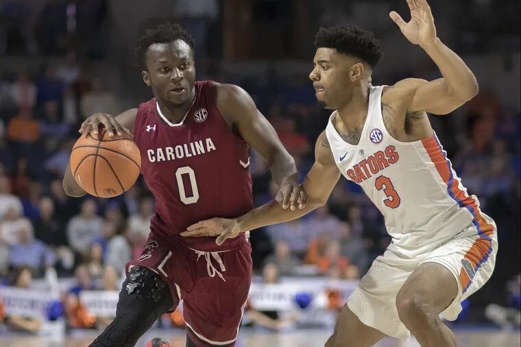 South Carolina guard David Beatty (0) dribbles against the defense by Florida guard Jalen Hudson (3) during the first half of an NCAA college basketball game in Gainesville, Fla., Wednesday, Jan. 24, 2018. South Carolina won 77-72. (AP Photo/Ron Irby)