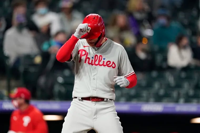 The Phillies' Rhys Hoskins taps his helmet as he crosses home plate after hitting a three-run home run off Rockies reliever Jhoulys Chacin during the sixth inning.