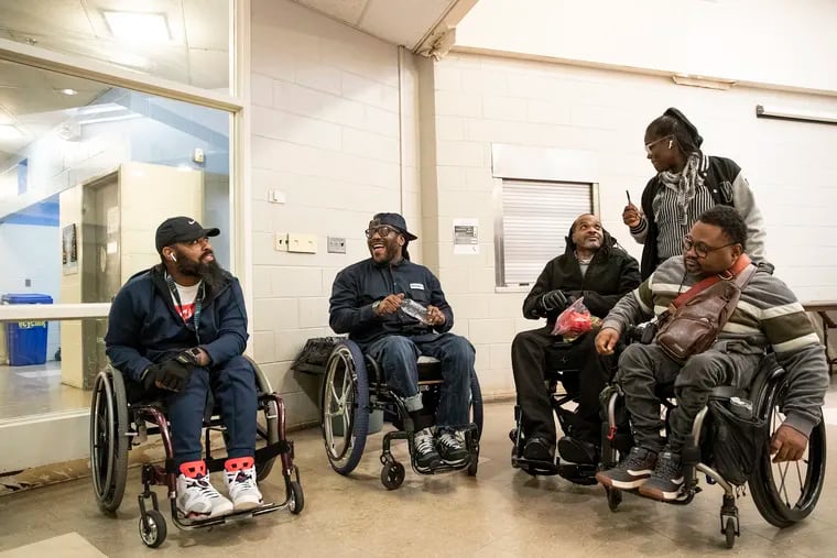 From left, Jalil Frazier, Tyrone Shoemake, Charles Horton and Jaleel King laugh and joke around with group facilitator Victoria Wylie after their survivors group meeting at the Carousel House in West Philadelphia on Monday evening, Nov. 18, 2019.