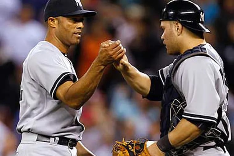 Mariano Rivera is congratulated by Russell Martin after closing out his 600th career game. (Elaine Thompson/AP)