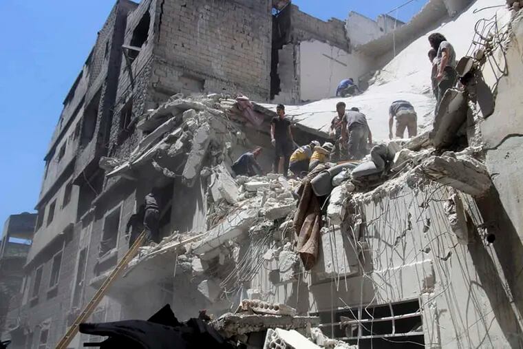This photo provided by the Syrian Civil Defense White Helmets, which has been authenticated based on its contents and other AP reporting, shows Civil Defense workers inspecting a damaged building after an airstrike by Syrian government forces, in the town of Ariha, in the northwestern province of Idlib, Syria, Monday, May 27, 2019. Syria's White Helmets say at least six people were killed and 10 remain under rubble following government air raids on a town in the rebel's last stronghold. (Syrian Civil Defense White Helmets via AP)