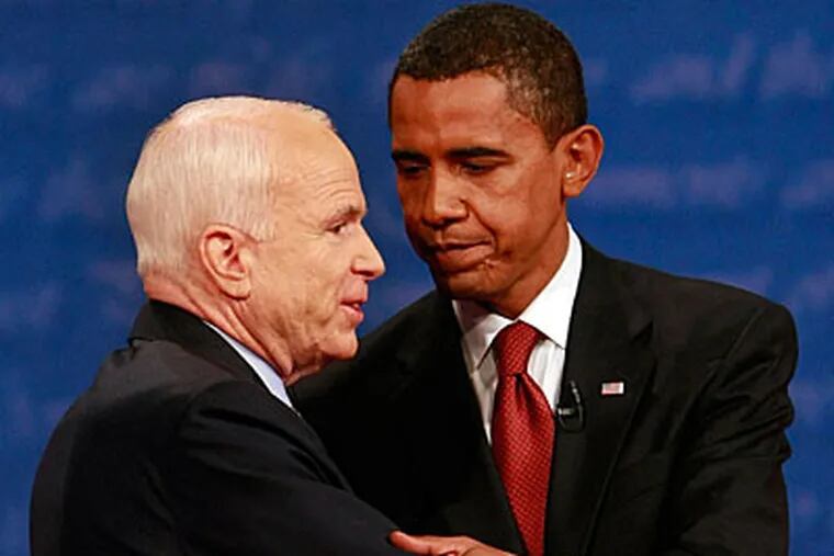 Sen. John McCain (left) and Sen. Barack Obama embrace after the presidential debate last night.