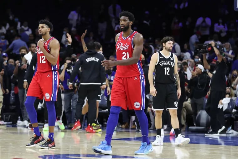 Tobias Harris, left, and Joel Embiid of the Sixers walk off the court after their loss to the Nets at the Wells Fargo Center on Oct. 22, 2021.