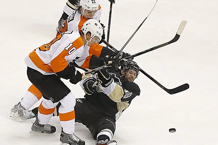 The Flyers' Brayden Schenn and Luke Schenn chase after the puck with the Penguins' Brian Gibbons. (Keith Srakocic/AP)