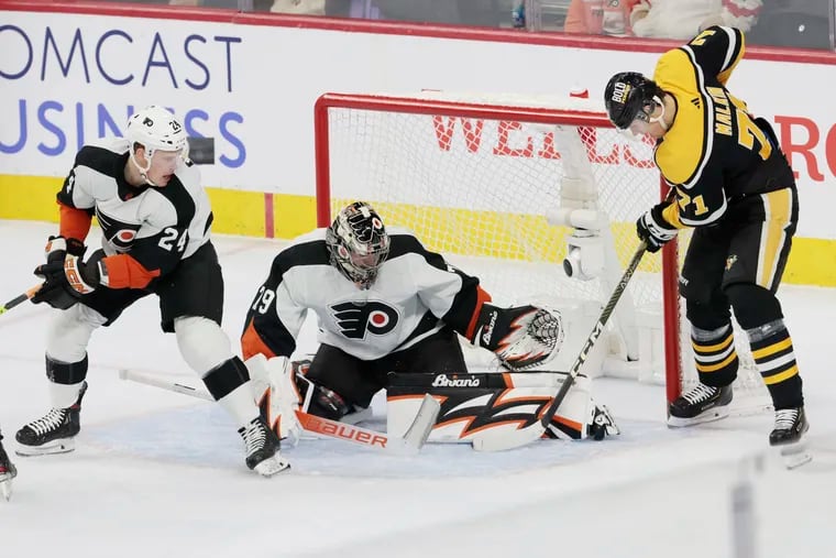 Flyers goalie Carter Hart stops a shot by the Penguins Evgeni Malkin on Friday.