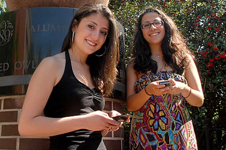 Temple students Natalie Ramos-Castillo (left) and Eva Alkasov say they text so frequently that they have to fight the impulse to use text-speak when it's not appropriate. (Tom Gralish / Staff)