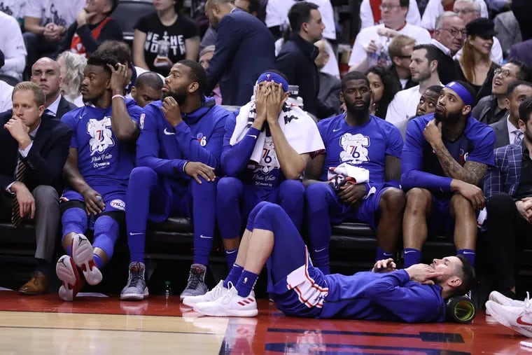 The dejected Sixers bench, including Tobias Harris (center), during their loss to the Raptors in Game 5 on Tuesday night.