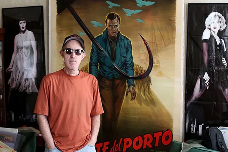 Mark del Costello , photographer, film and music promoter, and movie poster collector, stands in front of an &quot;On the Waterfront&quot; poster at his home in Burlington City. DAVID SWANSON / Staff Photographer