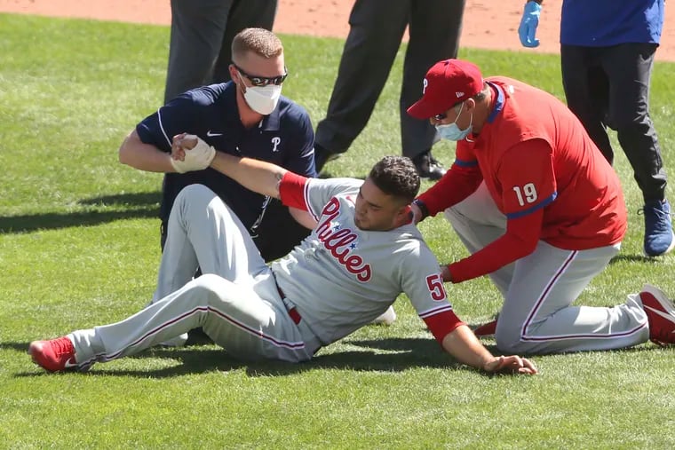 Phillies pitcher Jose Alvarez is helped after being hit by a ball hit by Toronto Blue Jays' Lourdes Gurriel Jr. during the fifth inning of Game 1.
