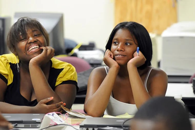 Nekia Sawyer (left) and Genehia Walton, both 15, at Teen Tech Camp, a five-day gathering sponsored by the Philadelphia chapter of the Society for Information Management. (Sharon Gekoski-Kimmel / Staff Photographer)