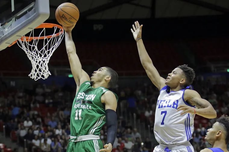 Sixers rookie Markelle Fultz (right) tries to block Celtics rookie Jayson Tatum during a summer league game.