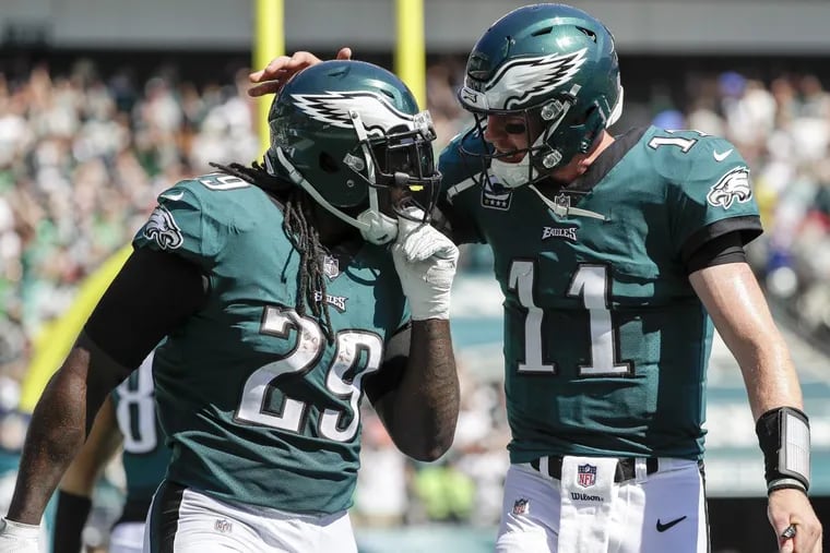 Eagles quarterback Carson Wentz chats with running back LeGarrette Blount during Sunday’s game against the Giants.