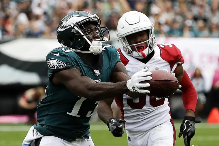 Eagles wide receiver Nelson Agholor catches the football on his way to a 72-yard touchdown reception against Arizona Cardinals safety Budda Baker.
