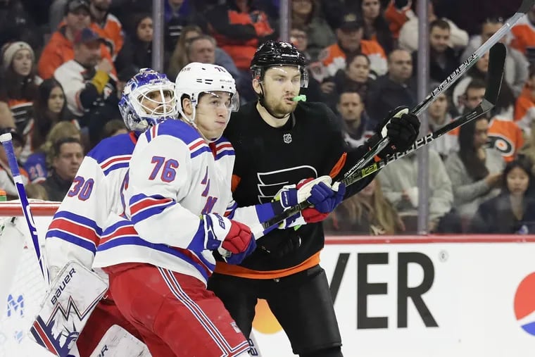 Flyers left winger James van Riemsdyk battles in front against New York Rangers defenseman Brady Skjei and goaltender Henrik Lundqvist on Friday.