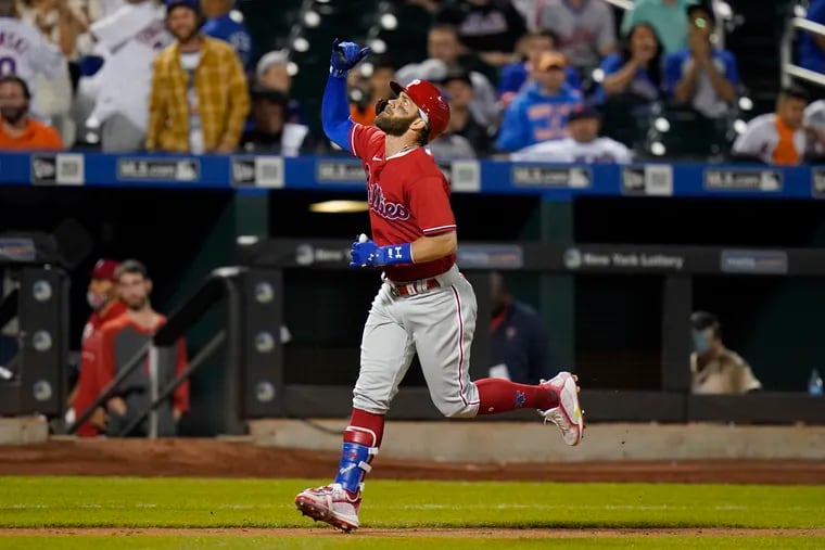 Philadelphia Phillies' Bryce Harper gestures as he approaches home plate after hitting a home run during the sixth inning of the second game of a doubleheader against the New York Mets Friday, June 25, 2021.