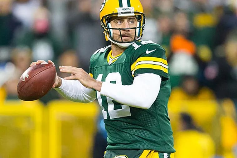Green Bay Packers quarterback Aaron Rodgers (12) throws a pass during the first quarter against the Chicago Bears at Lambeau Field.