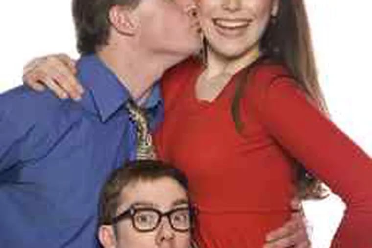 Anthony Lawton kisses one of his three flight-attendant fiancees, Jessica DalCanton, with buddy Tony Braithwaite caught in the middle, in Act II Playhouse's &quot;Boeing-Boeing.&quot;