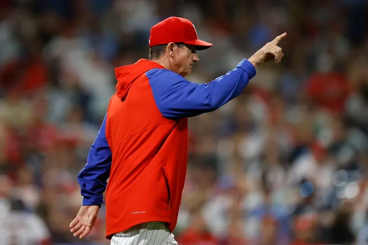 Phillies interim manager Rob Thomson points for a new pitcher during a pitching change against the Arizona Diamondbacks.
