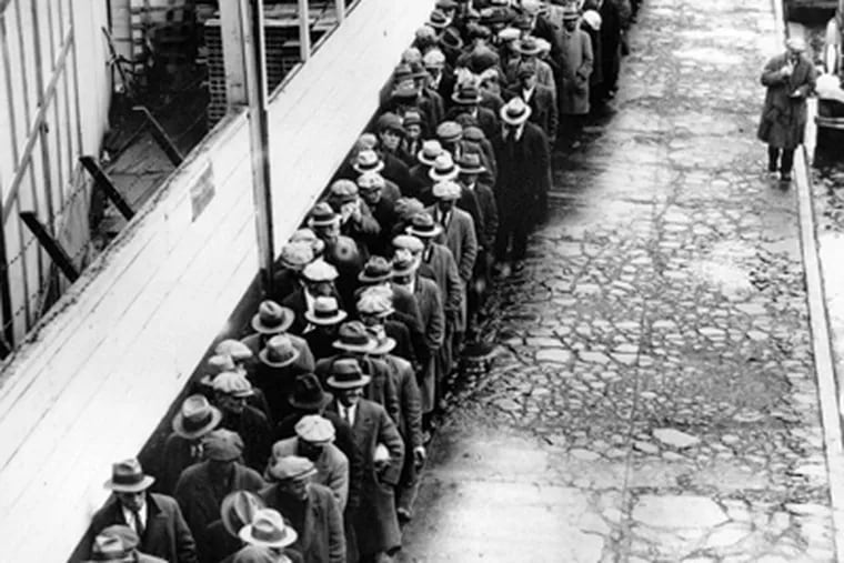Jobless and homeless men in New York stand in line for a free meal during the Great Depression. (Associated Press)