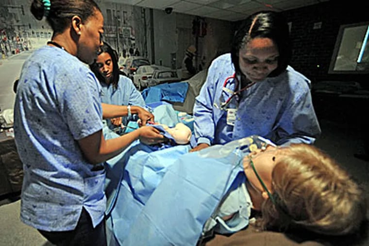 Plantation General Hospital nurses Monique Dixon, from left, Sandy Cadet and Jascinth Brown train for a breech birth delivery without a doctor present using a high tech mannequin in West Palm Beach, Florida. They are training at the Florida Atlantic University Simulation Center. (Mark Randall / South Florida Sun-Sentinel / MCT)
