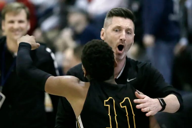 Moorestown head coach Shawn Anstey hugs senior Nick Cartwright-Atkins after 60-59 win over Haddonfield in the Tournament of Champions quarterfinals.